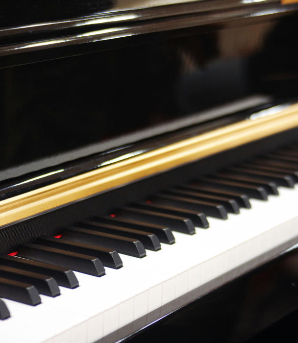 magnificent grand piano on a dark stage, dramatic top light, reflective black floor, classical conce