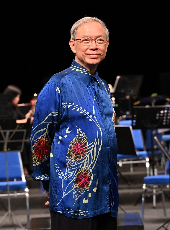dignified elderly male classical conductor in formal tuxedo, portrait in a concert hall, soft cinema